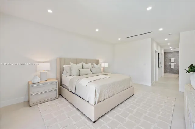 a large white bed in a white room