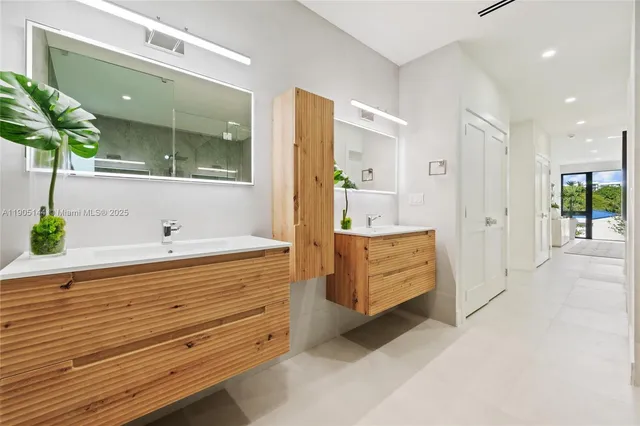 a bathroom with a tub sink and mirror