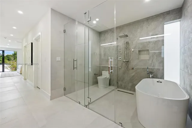 a bathroom with a shower a bathtub and a sink