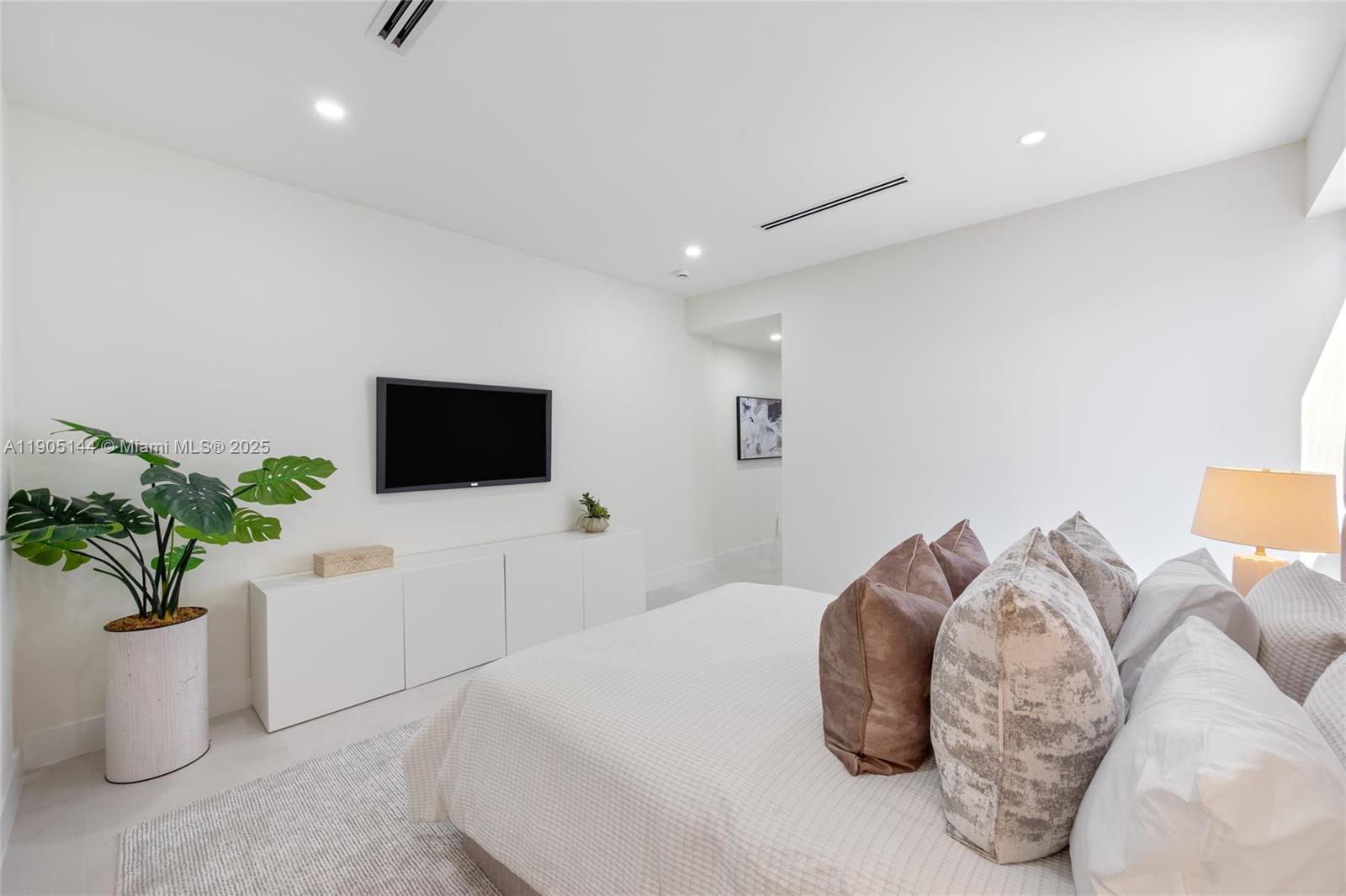 2127 Southwest 11th Terrace Miami, FL 33135 - Photo 17 of 28 a bedroom with a bed and a potted plant