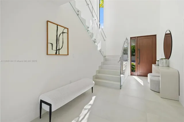 a view of staircase with white walls and a potted plant