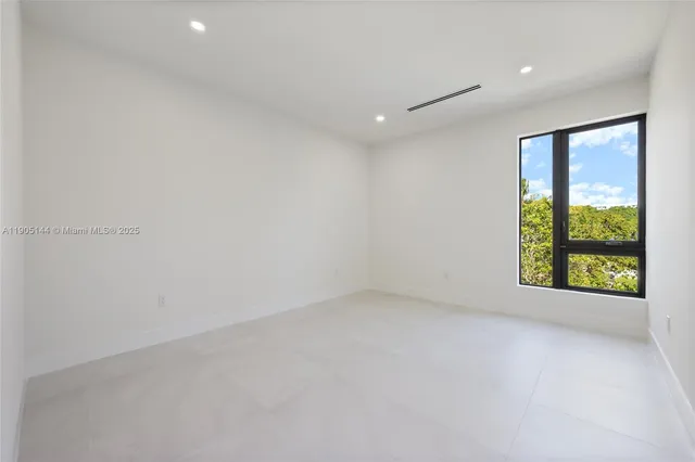 an empty room with large windows