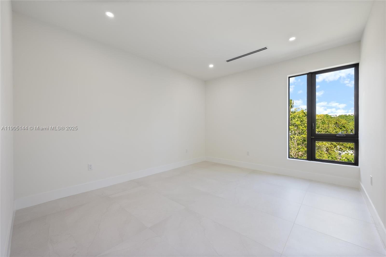 2127 Southwest 11th Terrace Miami, FL 33135 - Photo 21 of 28 an empty room with large windows