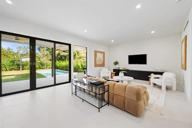 a living room with furniture and large windows