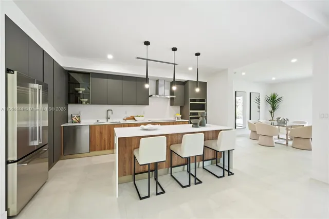 a large kitchen with a table and chairs
