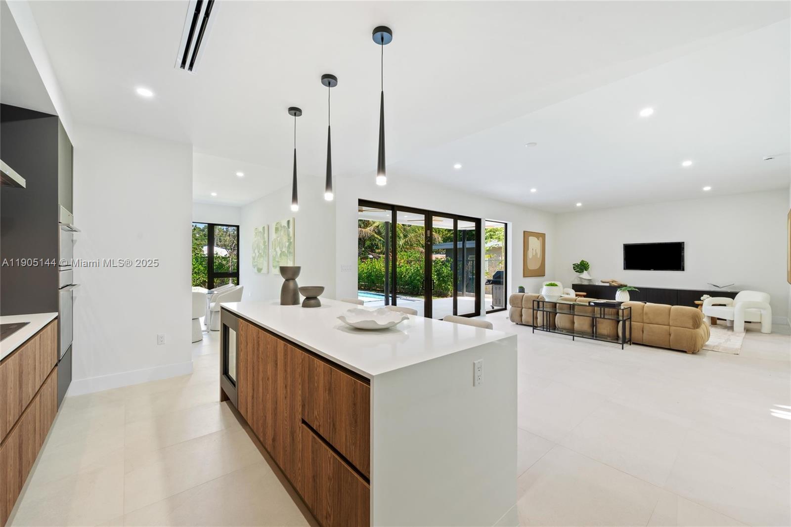 2127 Southwest 11th Terrace Miami, FL 33135 - Photo 7 of 28 a kitchen with stainless steel appliances granite countertop a sink and a stove