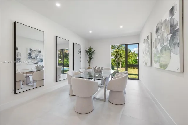 a living room with patio furniture and a potted plant