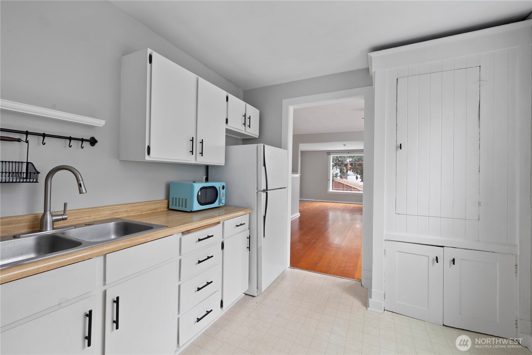 908 South 5th Street Tacoma, WA 98405 - Photo 5 of 6 a kitchen with white cabinets and sink