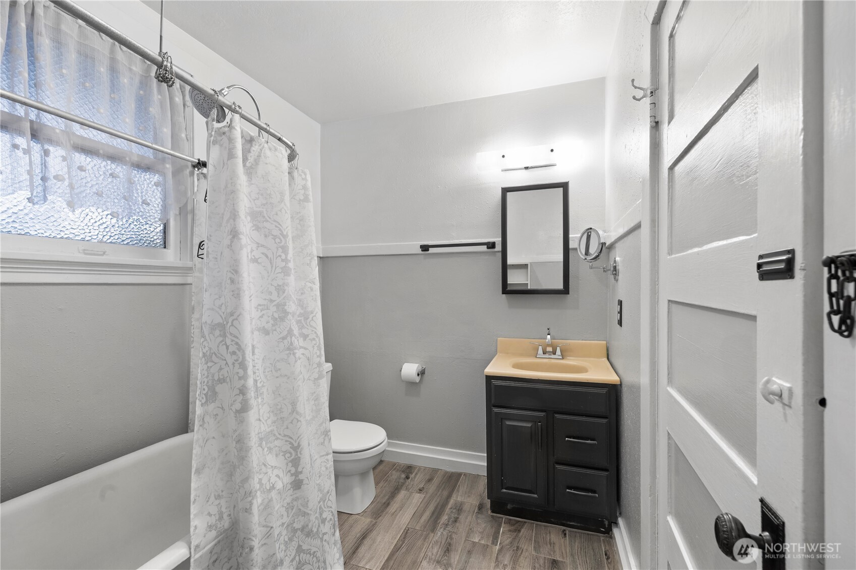 908 South 5th Street Tacoma, WA 98405 - Photo 6 of 6 a bathroom with a sink a toilet and shower