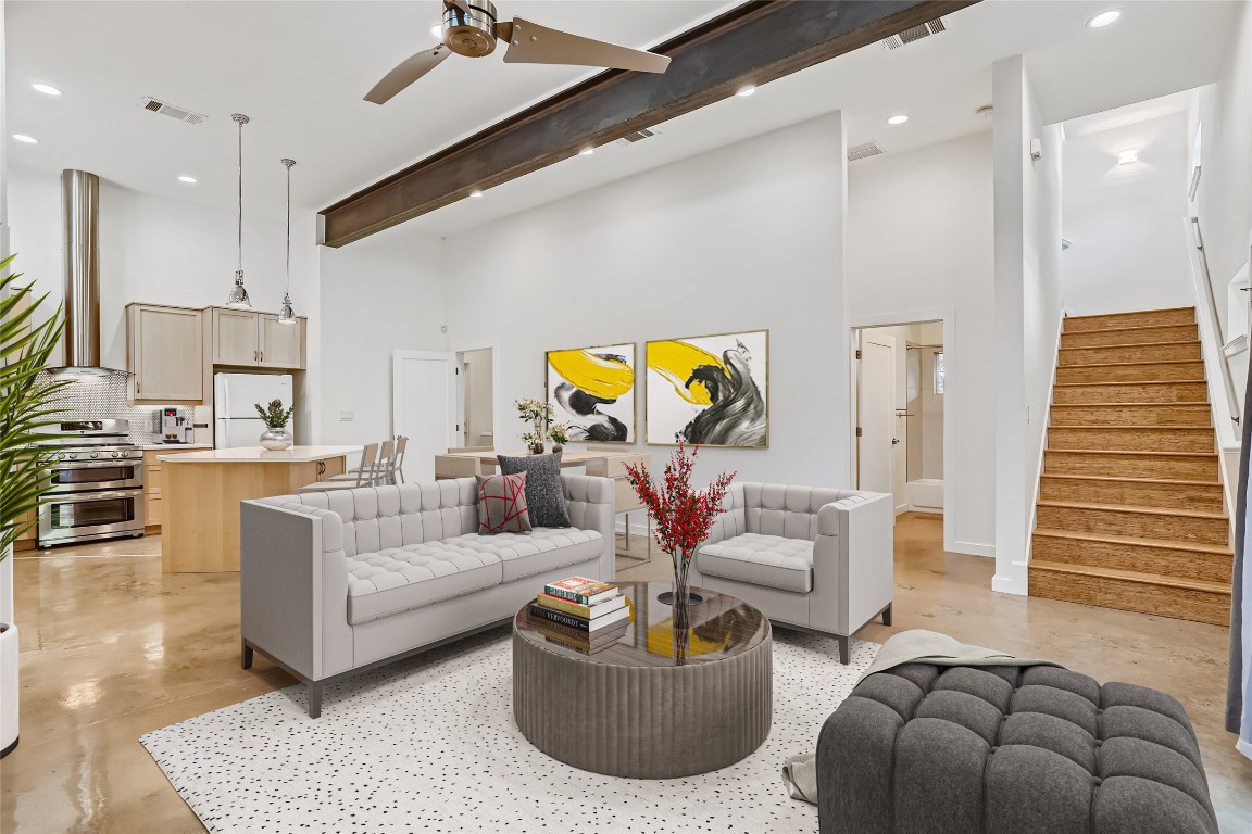 a living room with furniture and kitchen view