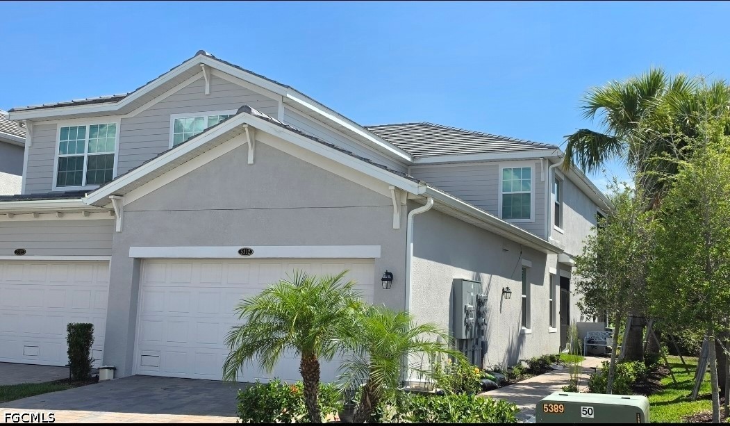 14191 Poppy Fld Loop, Unit 5312 Punta Gorda, FL 33955 - Photo 1 of 41 a front view of a house with garden