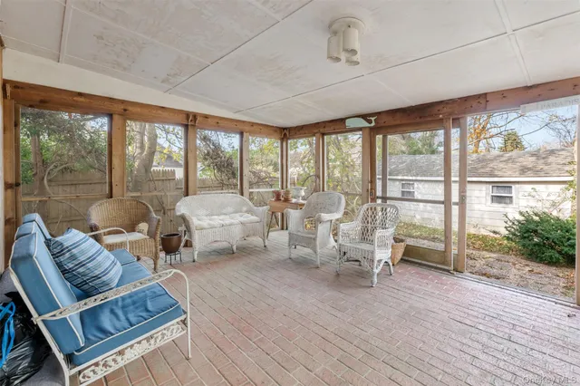 a living room with furniture and large windows