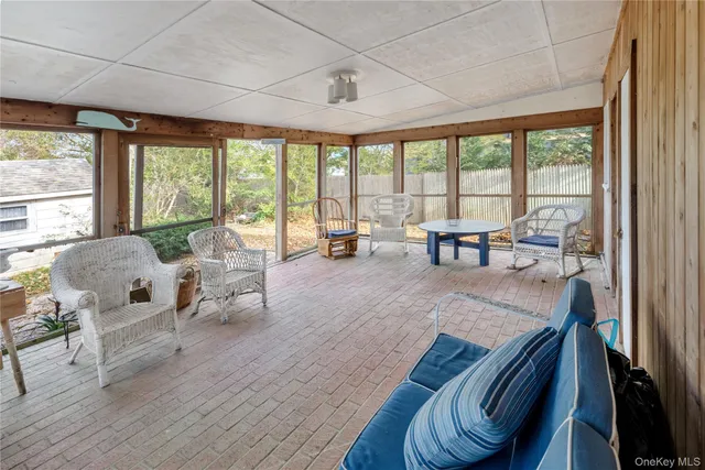 a living room with furniture and large windows