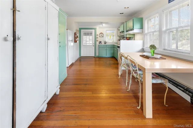 a dining room with furniture and wooden floor