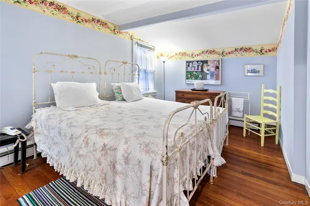 a bed sitting in a bedroom next to a chair