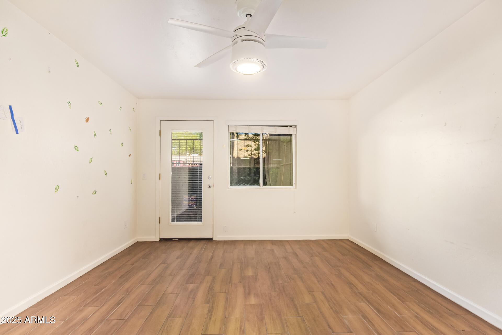 151 East Broadway Road, Unit 103 Tempe, AZ 85282 - Photo 20 of 27 an empty room with wooden floor and windows