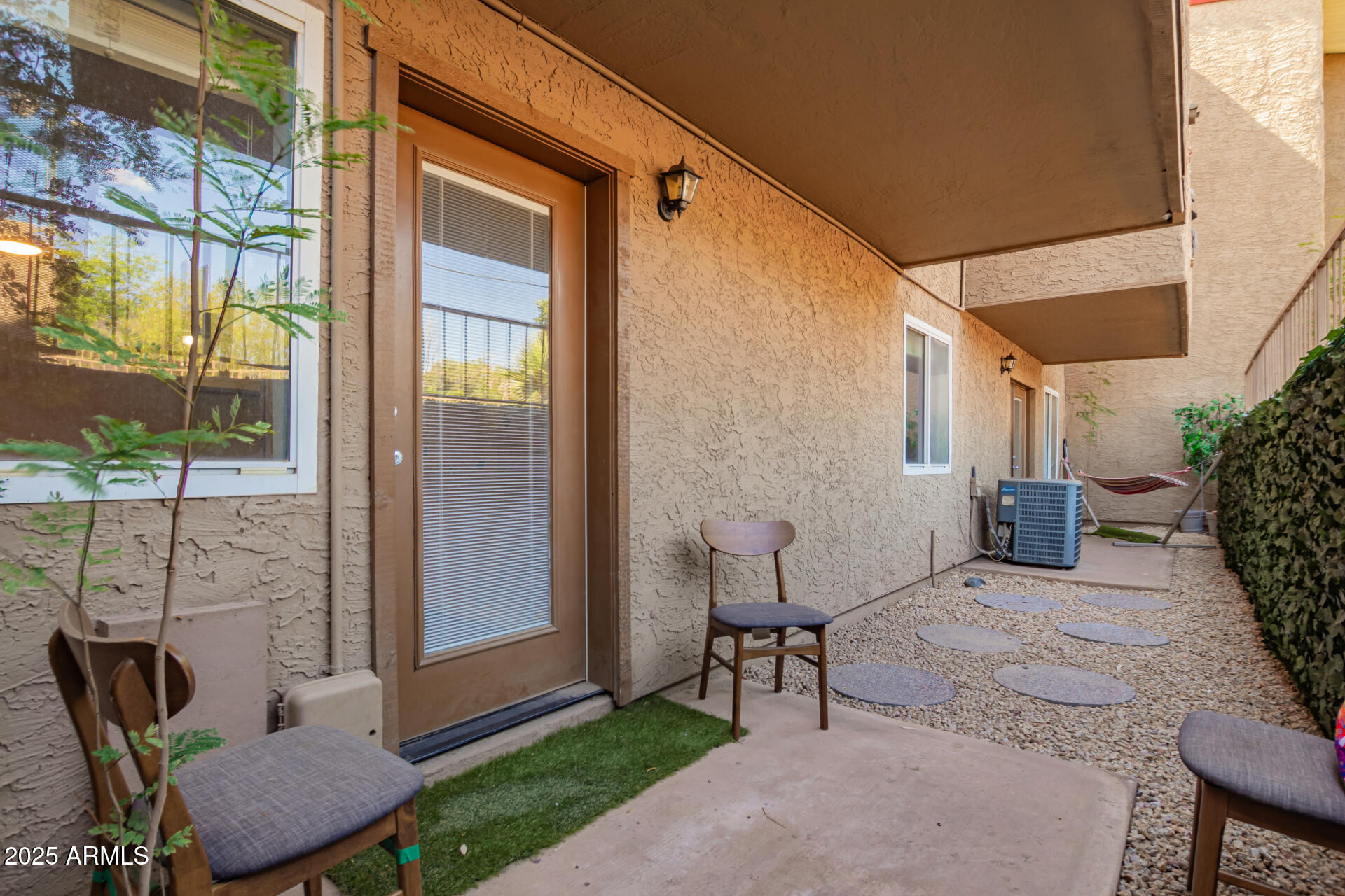 151 East Broadway Road, Unit 103 Tempe, AZ 85282 - Photo 23 of 27 a backyard of a house with outdoor seating