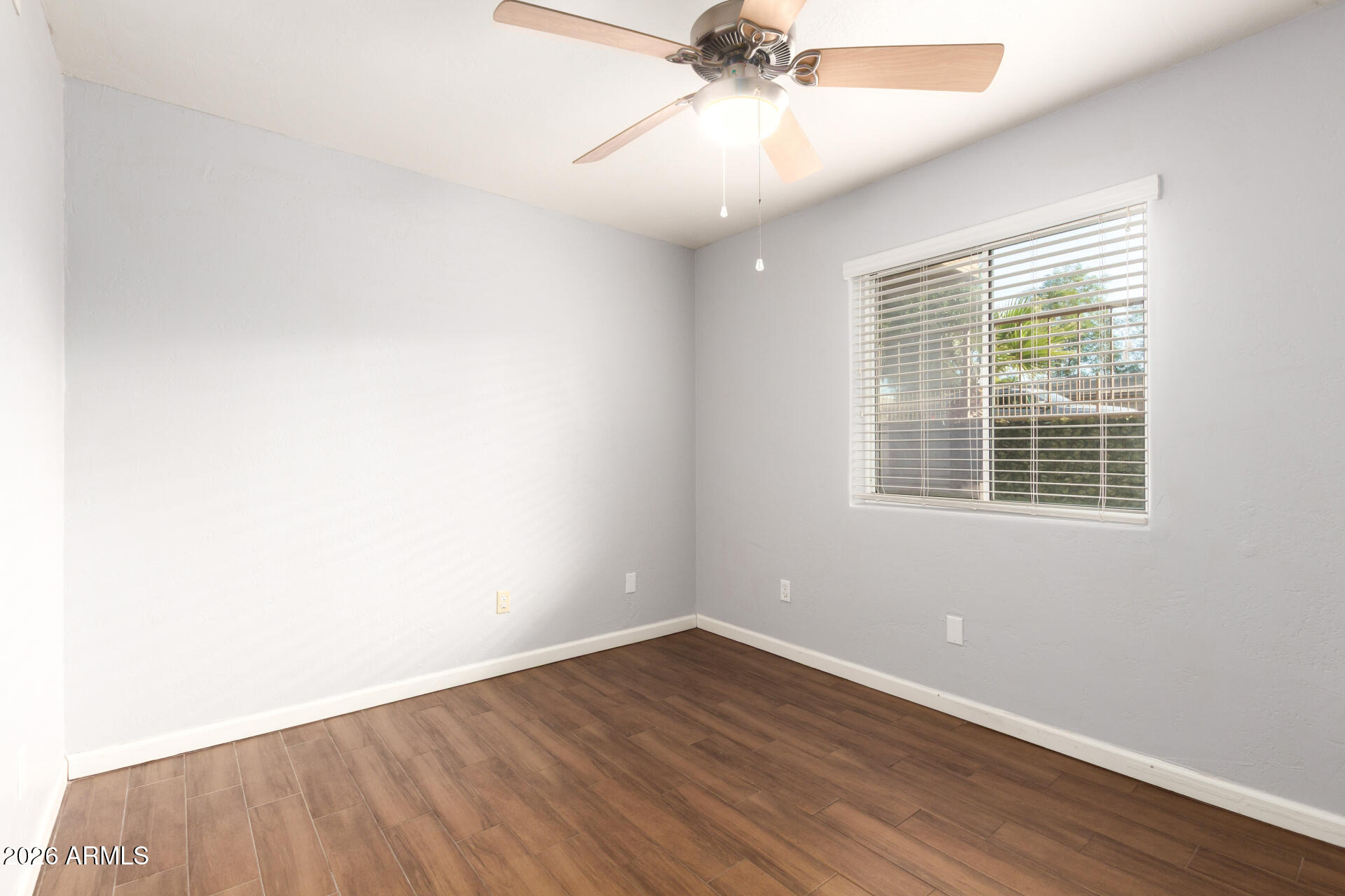 151 East Broadway Road, Unit 103 Tempe, AZ 85282 - Photo 24 of 33 an empty room with a window and a ceiling fan