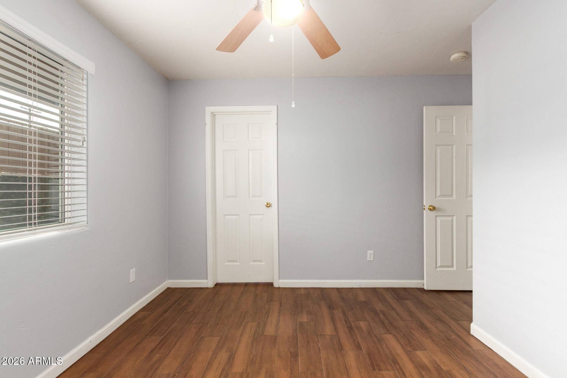 151 East Broadway Road, Unit 103 Tempe, AZ 85282 - Photo 26 of 33 an empty room with wooden floor and windows