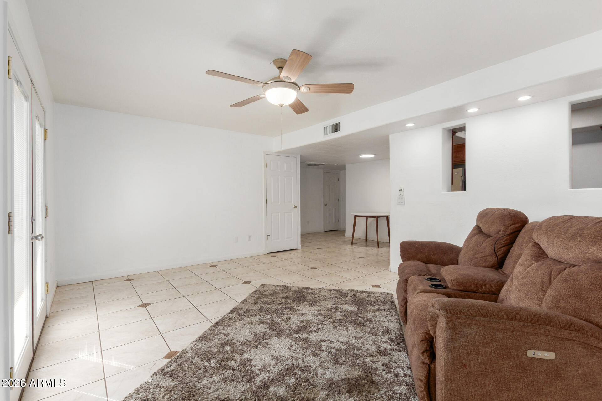 151 East Broadway Road, Unit 103 Tempe, AZ 85282 - Photo 8 of 33 a living room with furniture and a ceiling fan