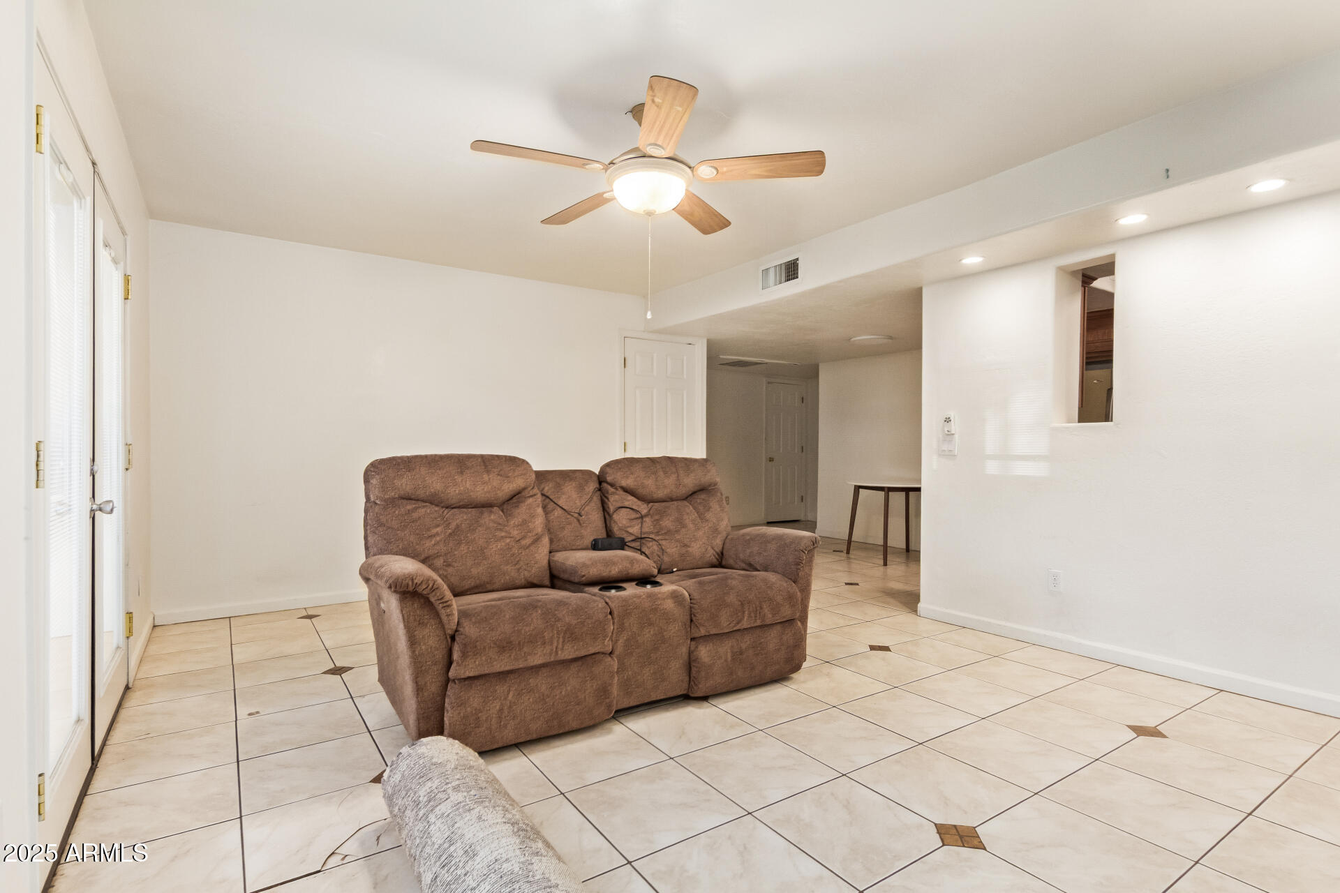 151 East Broadway Road, Unit 103 Tempe, AZ 85282 - Photo 8 of 27 a living room with furniture and a chandelier