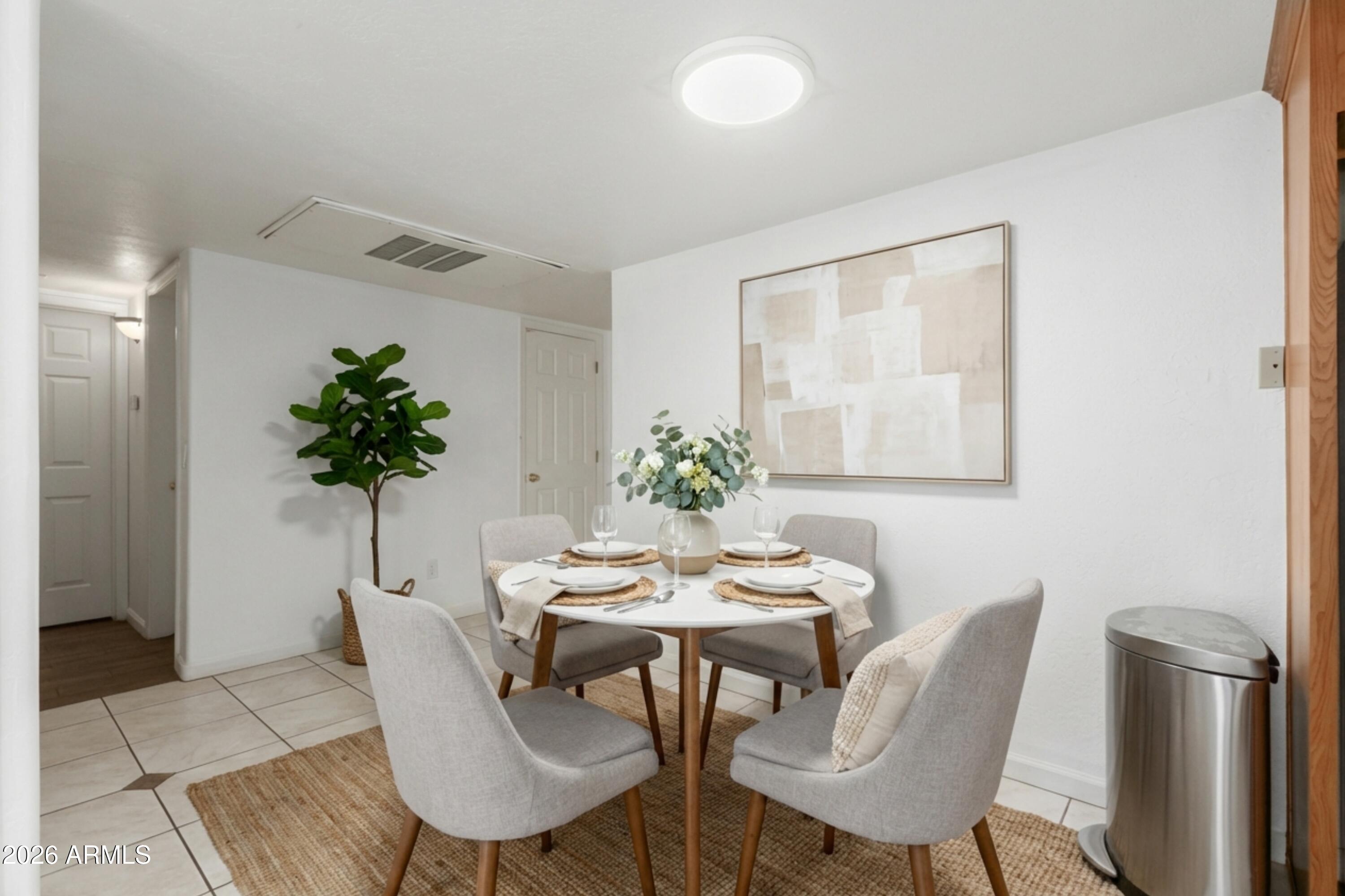 151 East Broadway Road, Unit 103 Tempe, AZ 85282 - Photo 9 of 33 a dining room with furniture and a potted plant