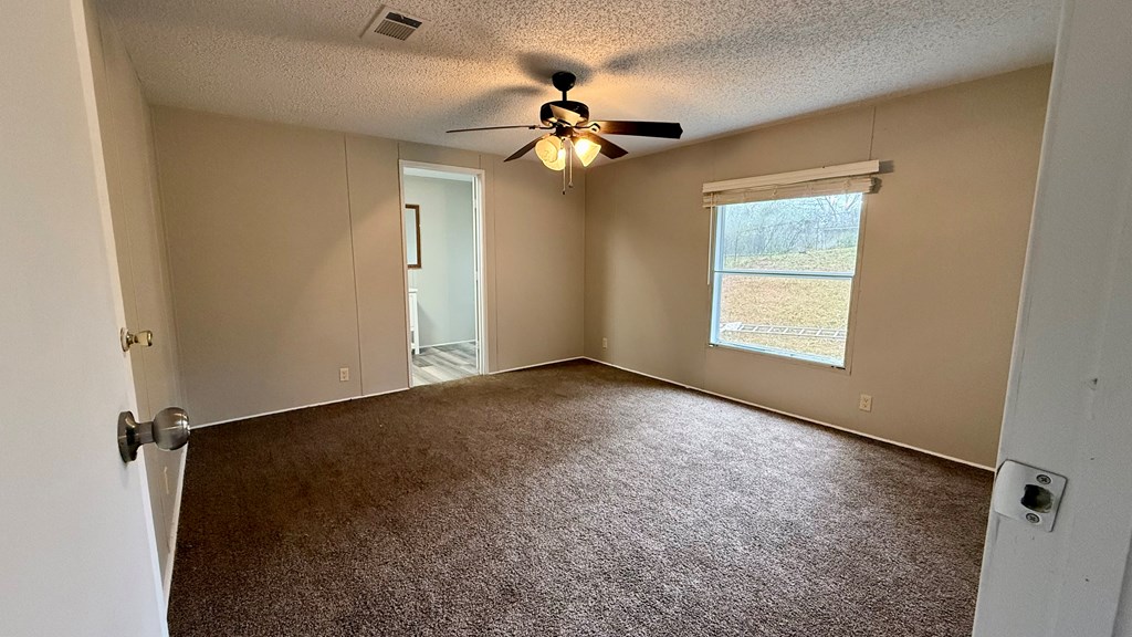 301 Satellite Circle Fortson, GA 31808 - Photo 15 of 24 an empty room with windows and fan