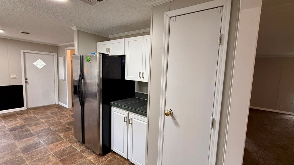 301 Satellite Circle Fortson, GA 31808 - Photo 8 of 24 a kitchen with a refrigerator and a sink