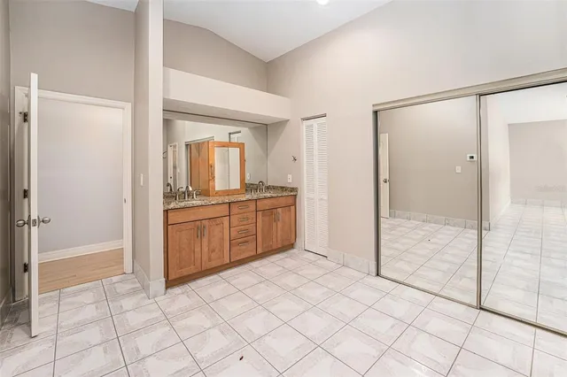 a view of a room with a chandelier fan and closet