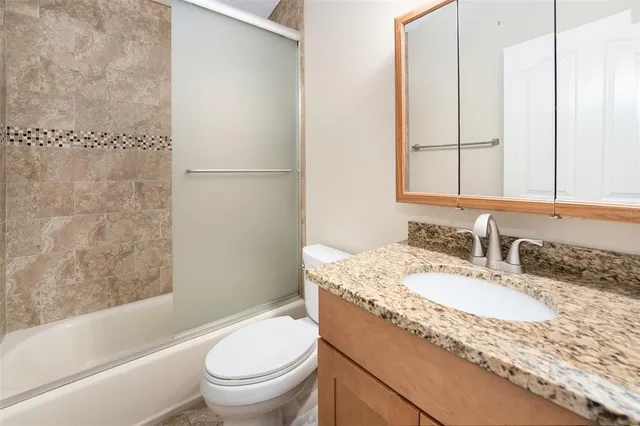 a view of a livingroom with a ceiling fan and window