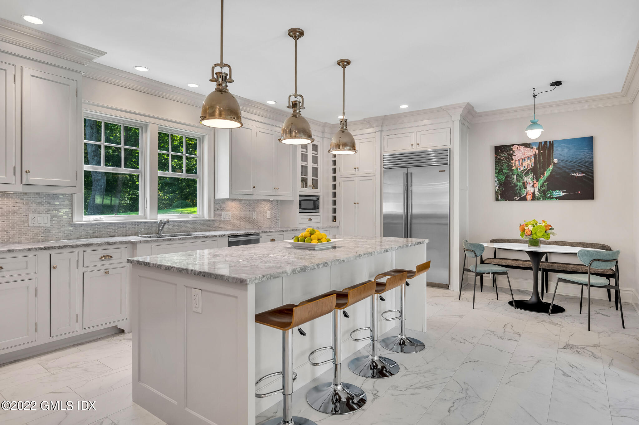 174 Cognewaugh Road Cos Cob, CT 06807 - Photo 11 of 37 a kitchen with stainless steel appliances kitchen island granite countertop a stove a sink a dining table and chairs