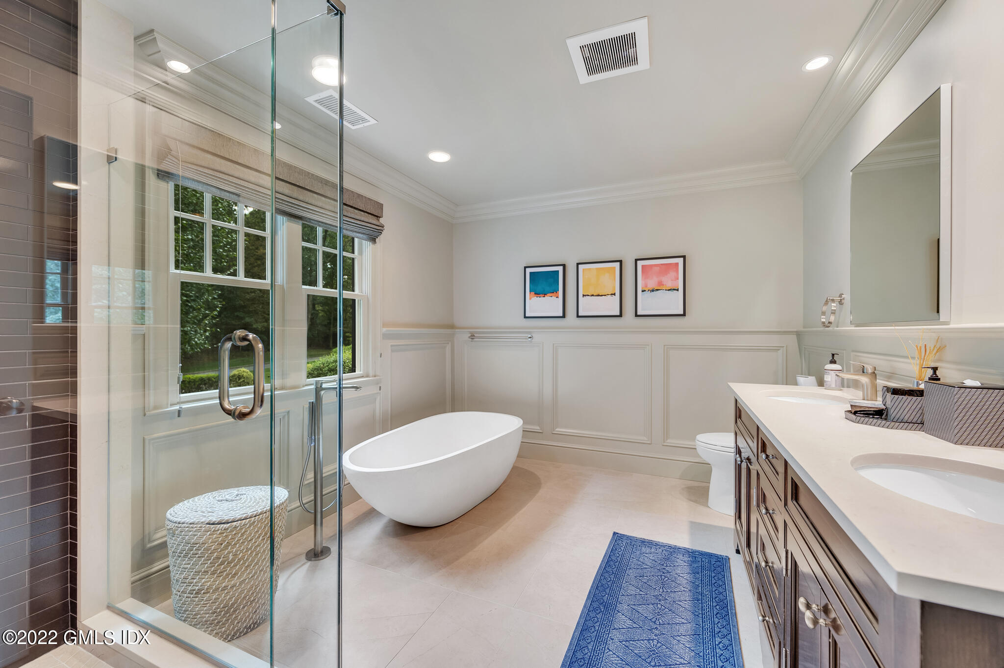 174 Cognewaugh Road Cos Cob, CT 06807 - Photo 21 of 37 a spacious bathroom with a double vanity sink a mirror and a bathtub
