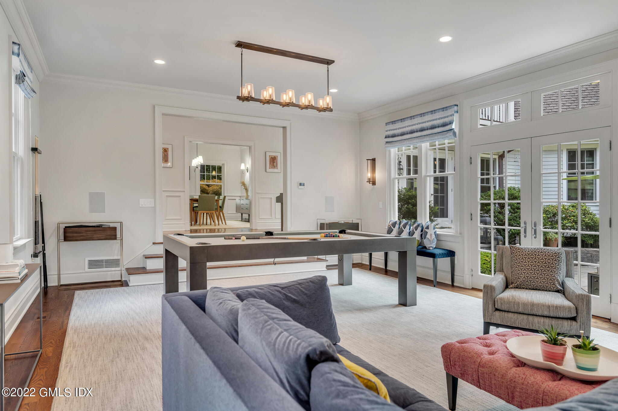 174 Cognewaugh Road Cos Cob, CT 06807 - Photo 8 of 37 a living room with furniture and a chandelier