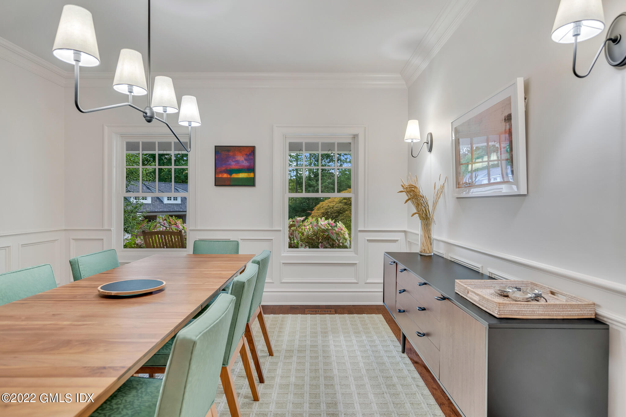 174 Cognewaugh Road Cos Cob, CT 06807 - Photo 10 of 37 a view of a dining room with furniture wooden floor and chandelier