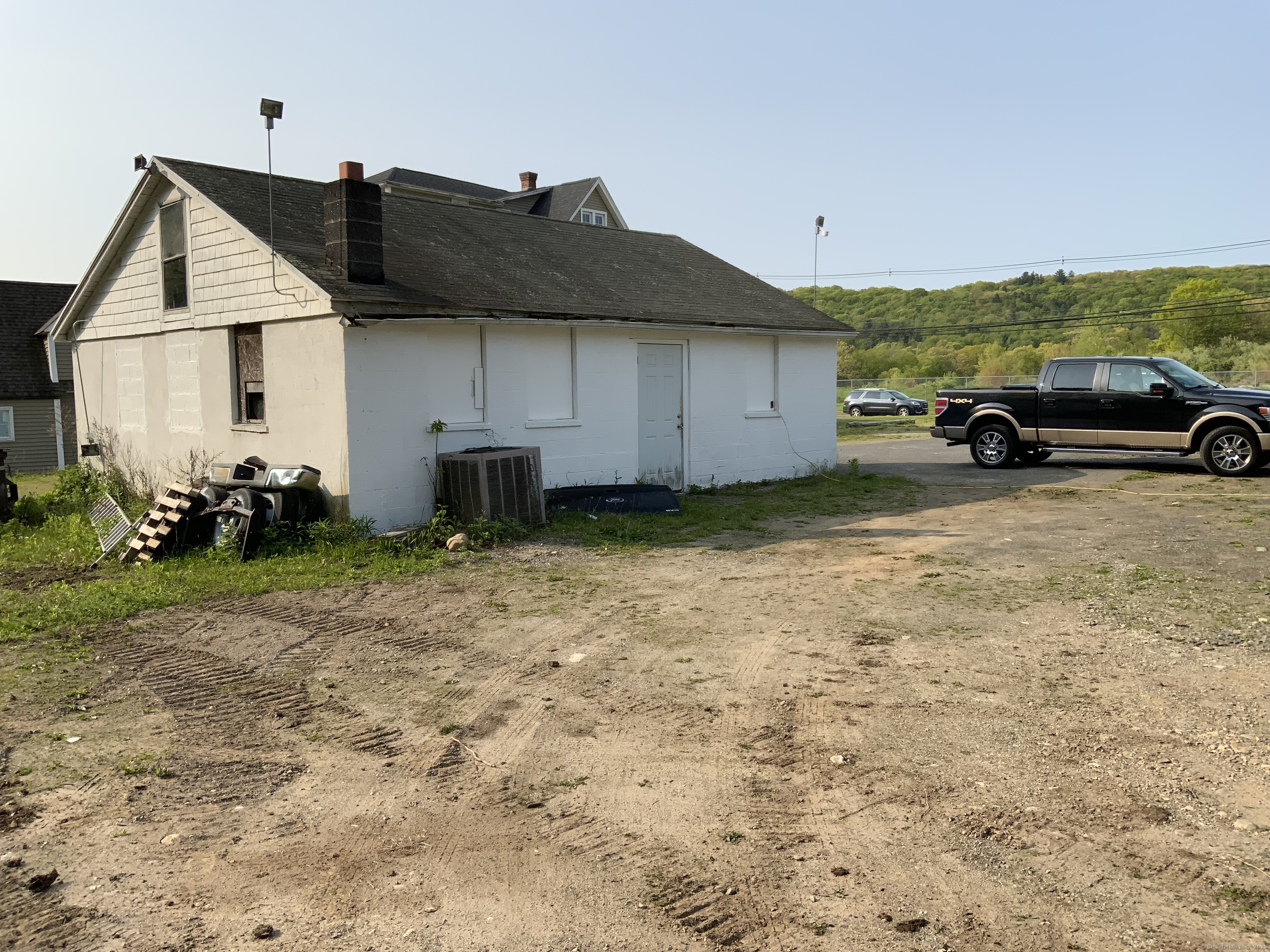 856 New Haven Road Naugatuck, CT 06770 - Photo 11 of 36 a view of a house that has a couple of cars parked in it