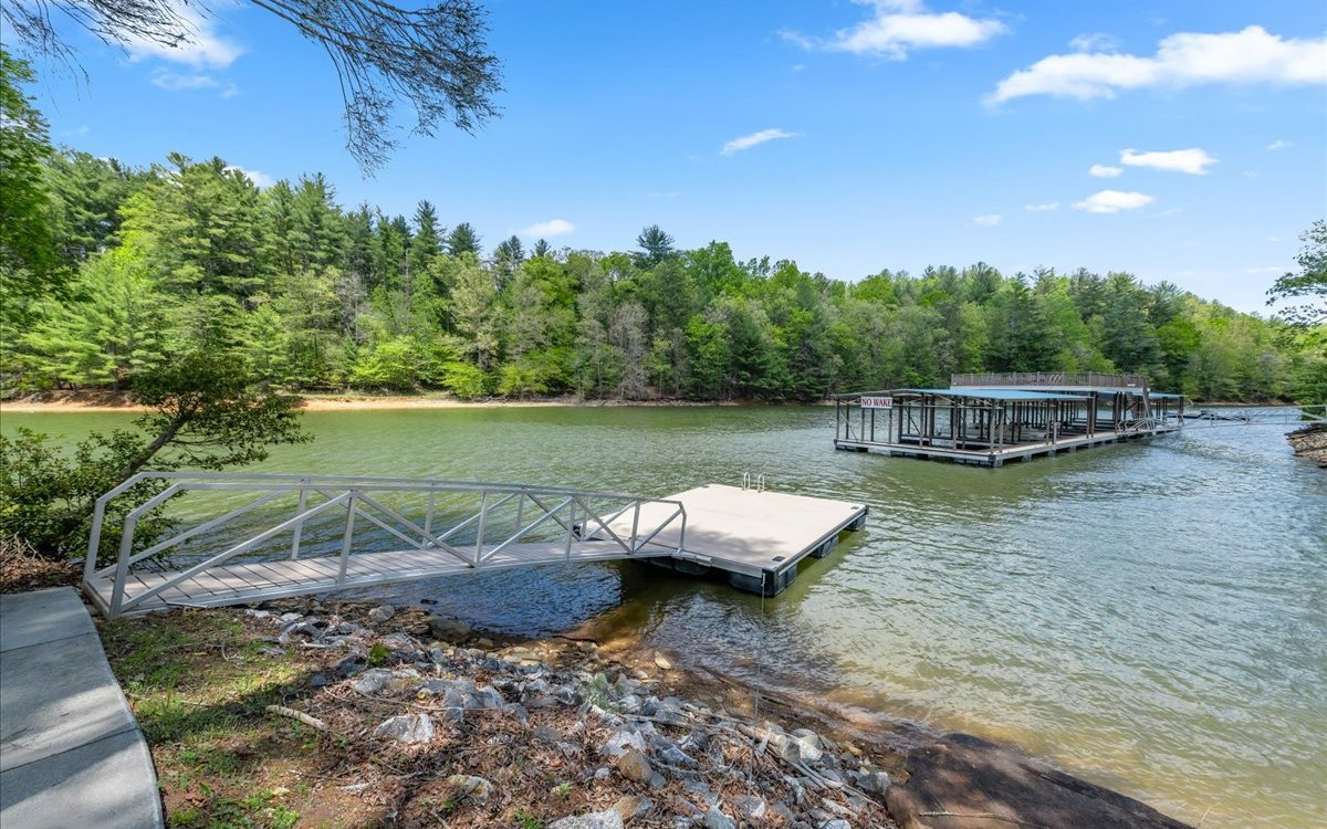 Lt158 Stables Loop Blairsville, GA 30512 - Photo 17 of 42 a view of a swimming pool with lawn chairs under an umbrella