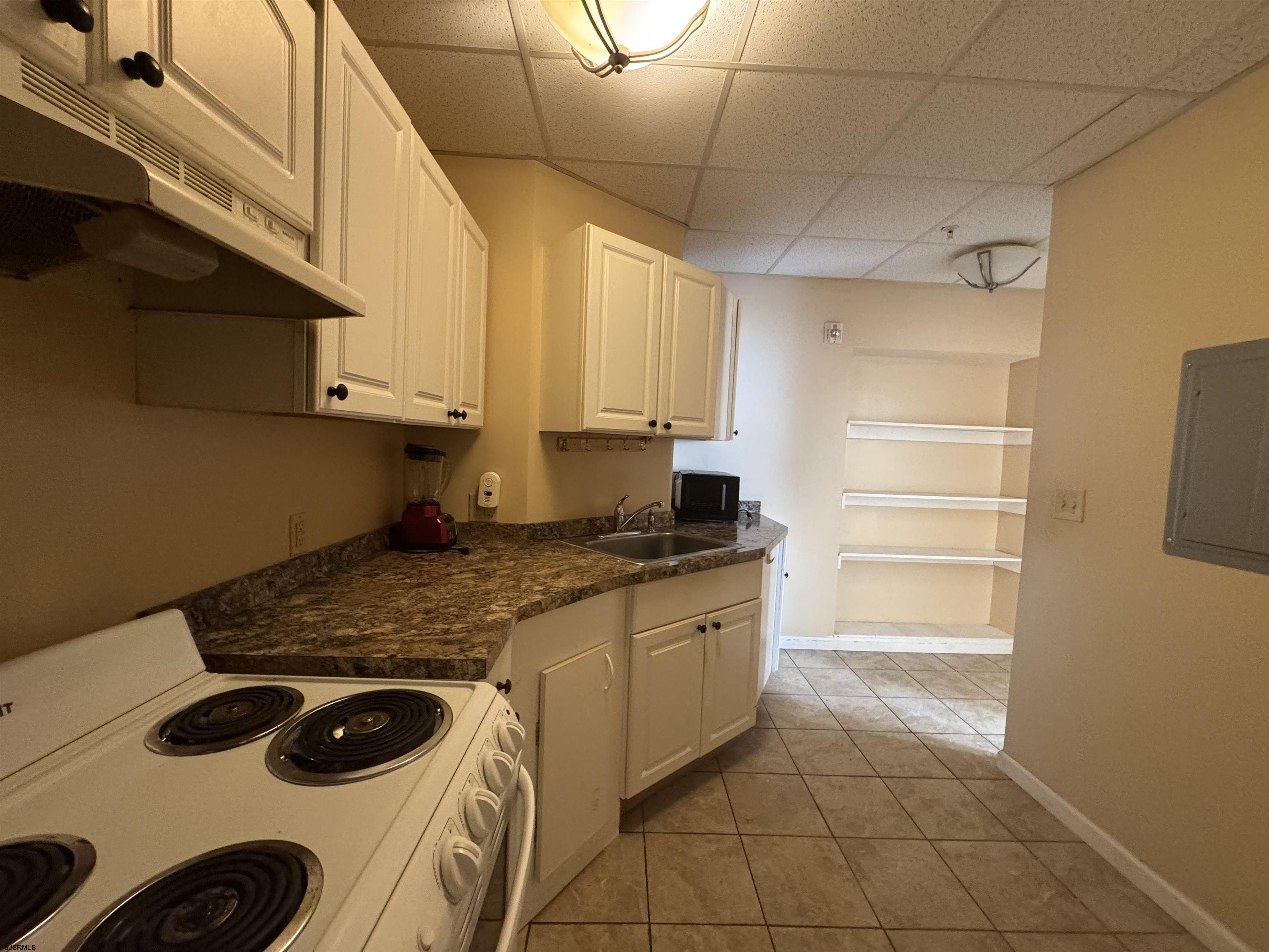 3201 Atlantic Avenue, Unit 25 Atlantic City, NJ 08401 - Photo 2 of 16 a kitchen with a stove and a refrigerator