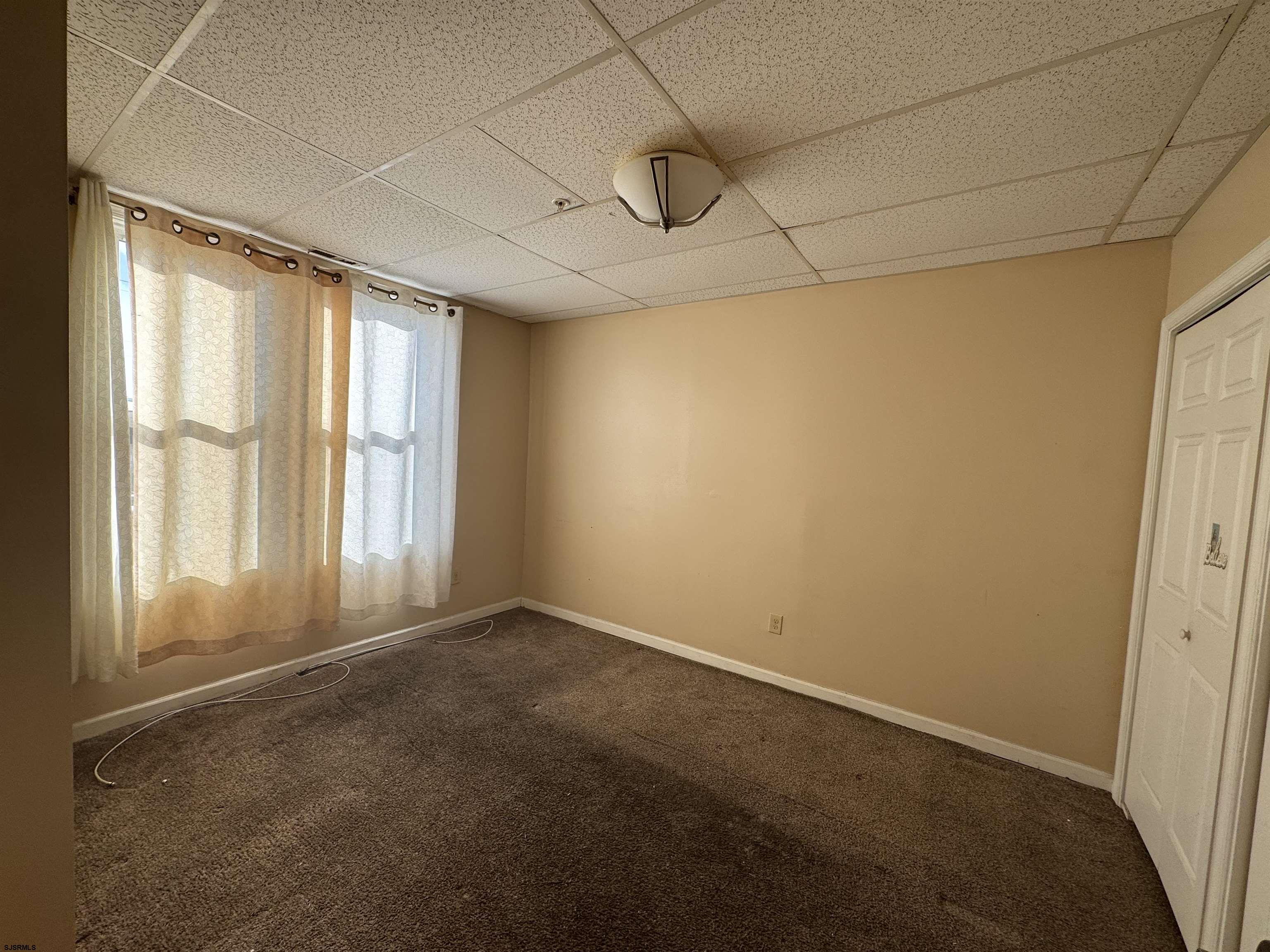 3201 Atlantic Avenue, Unit 25 Atlantic City, NJ 08401 - Photo 7 of 16 a view of an empty room with a window