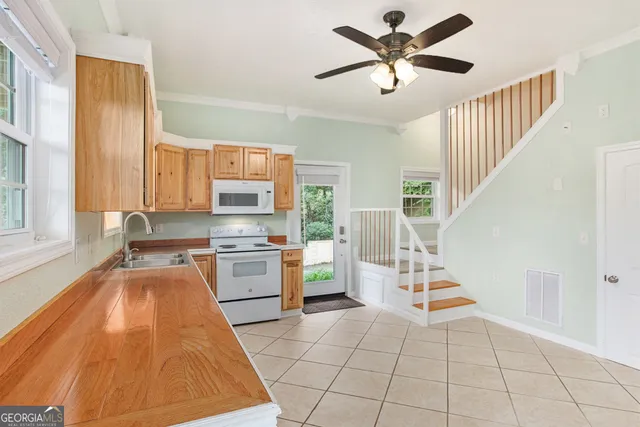 a kitchen with a cabinets a sink and appliances
