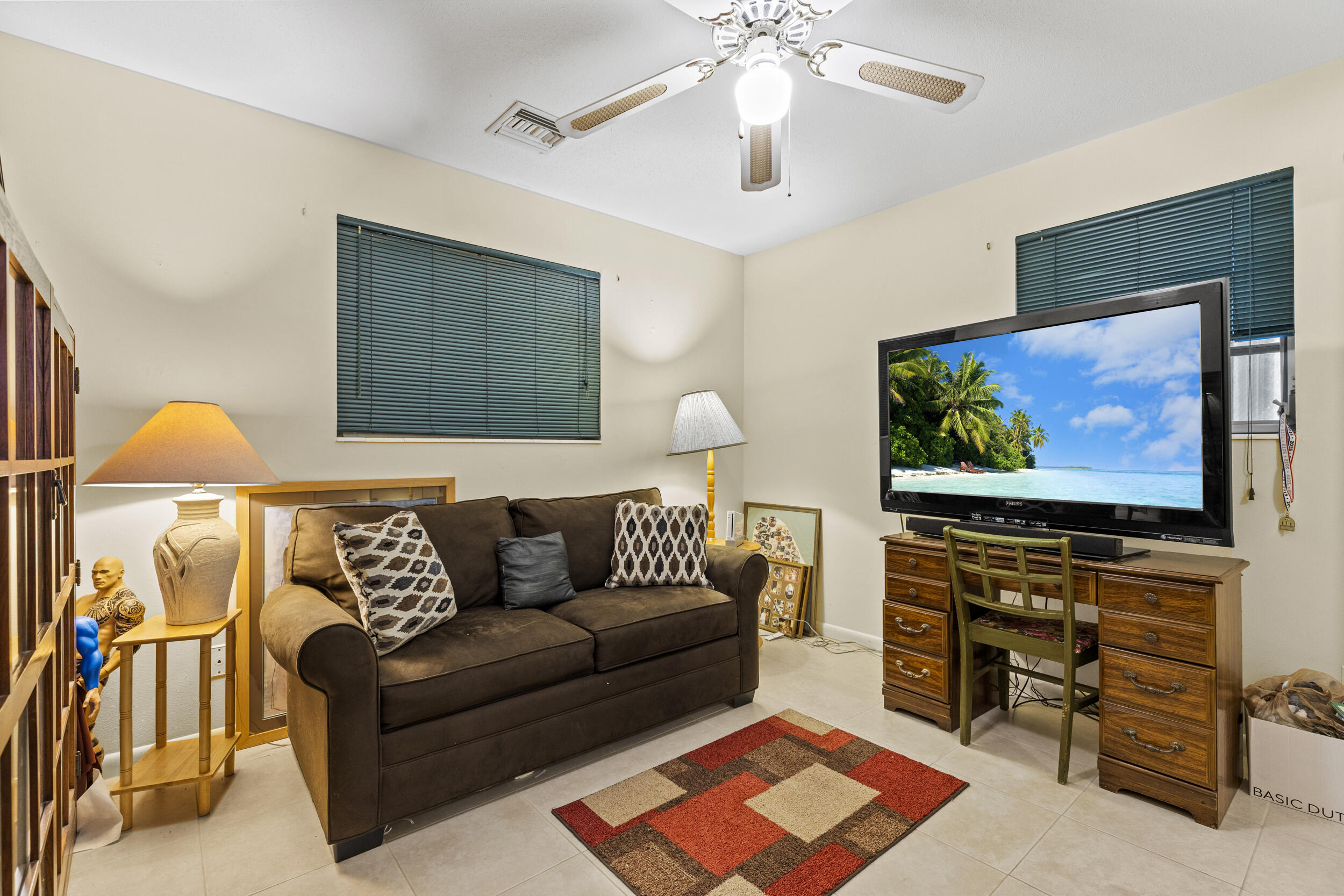333 Masters Road Palm Springs, FL 33461 - Photo 11 of 15 a living room with furniture and a flat screen tv