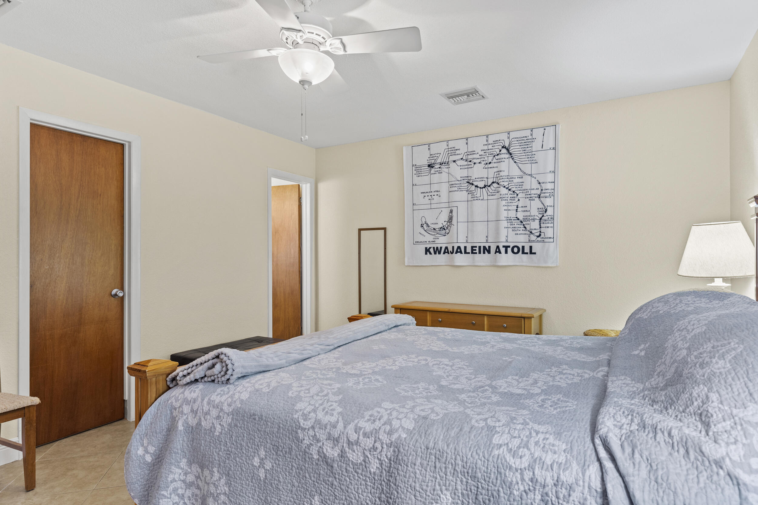 333 Masters Road Palm Springs, FL 33461 - Photo 12 of 15 a bedroom with a bed and a painting on the wall