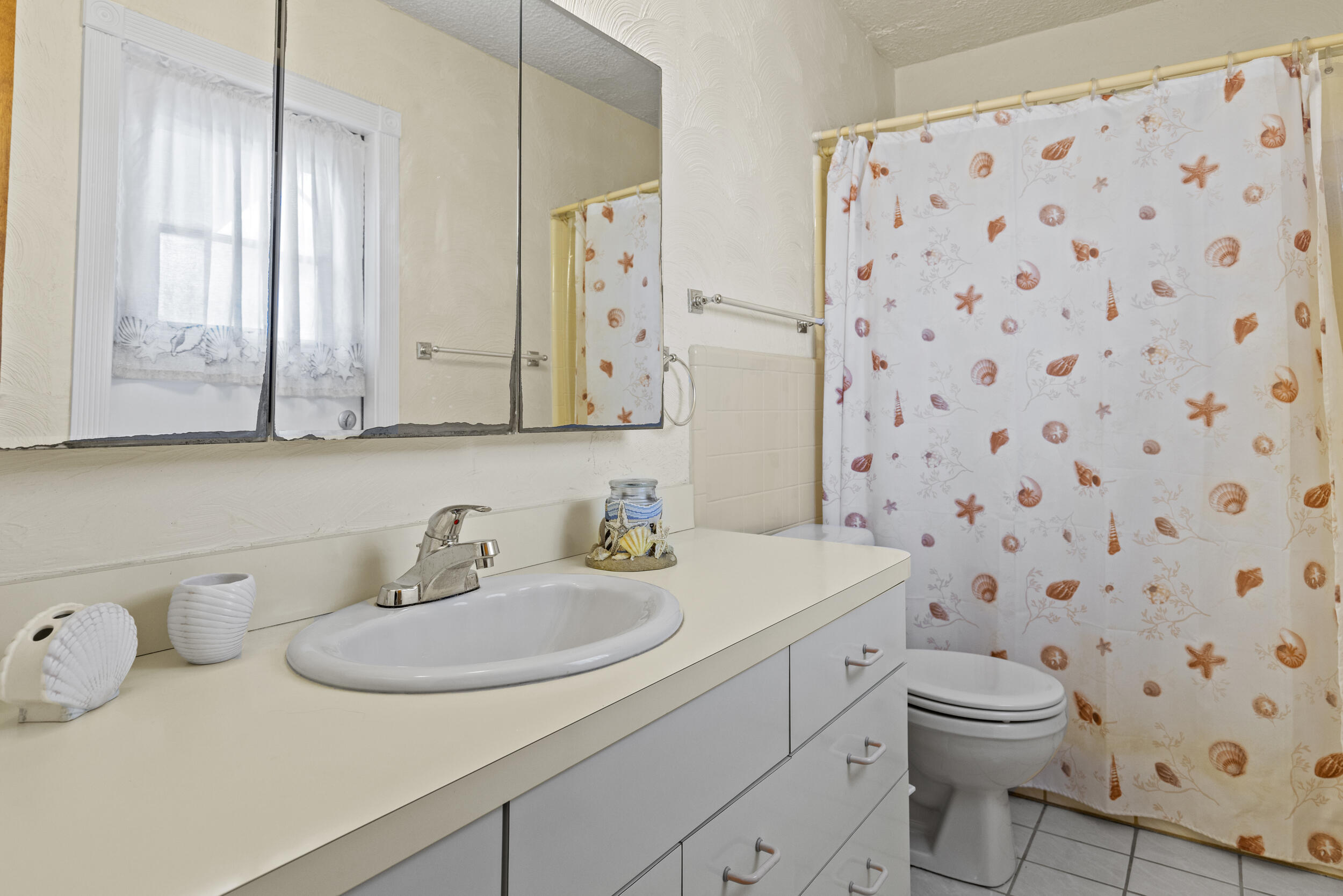 333 Masters Road Palm Springs, FL 33461 - Photo 13 of 15 a bathroom with a sink toilet and shower