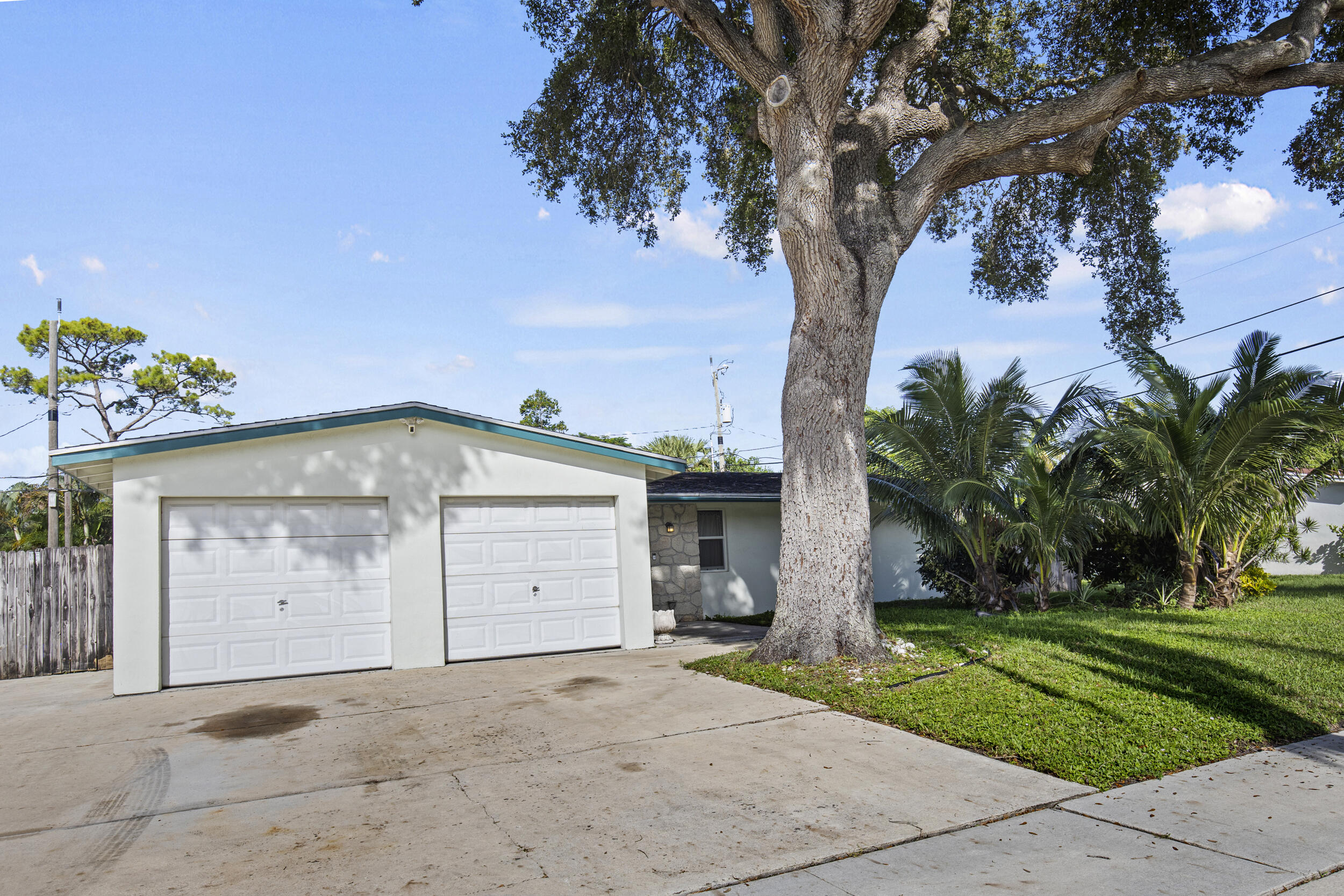 333 Masters Road Palm Springs, FL 33461 - Photo 2 of 15 a front view of a house with a yard and garage