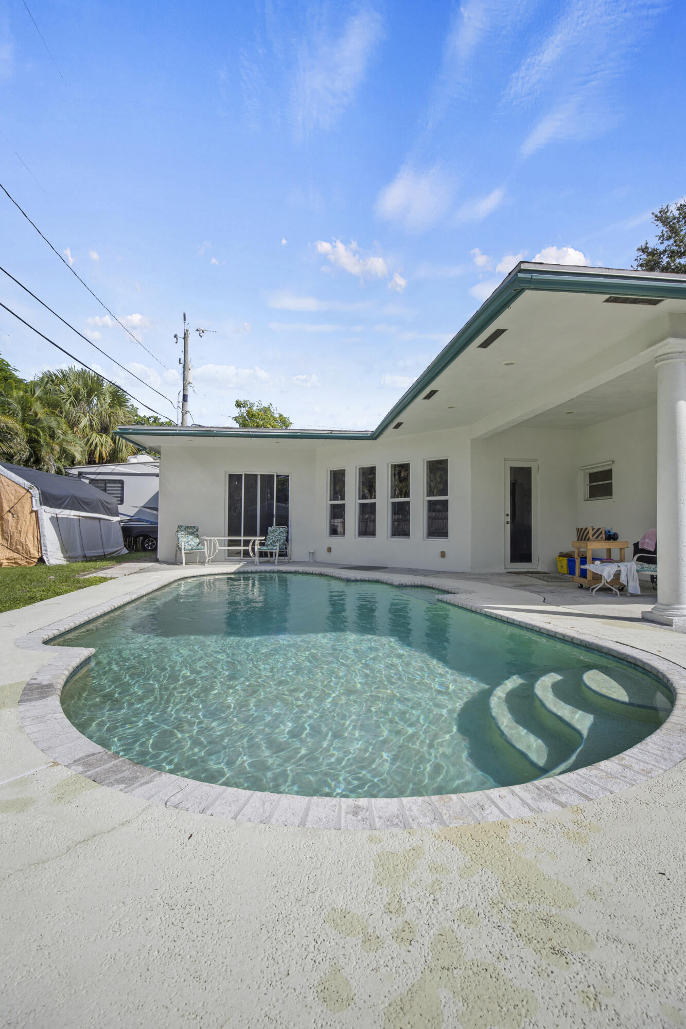 333 Masters Road Palm Springs, FL 33461 - Photo 8 of 15 a front view of a house with swimming pool