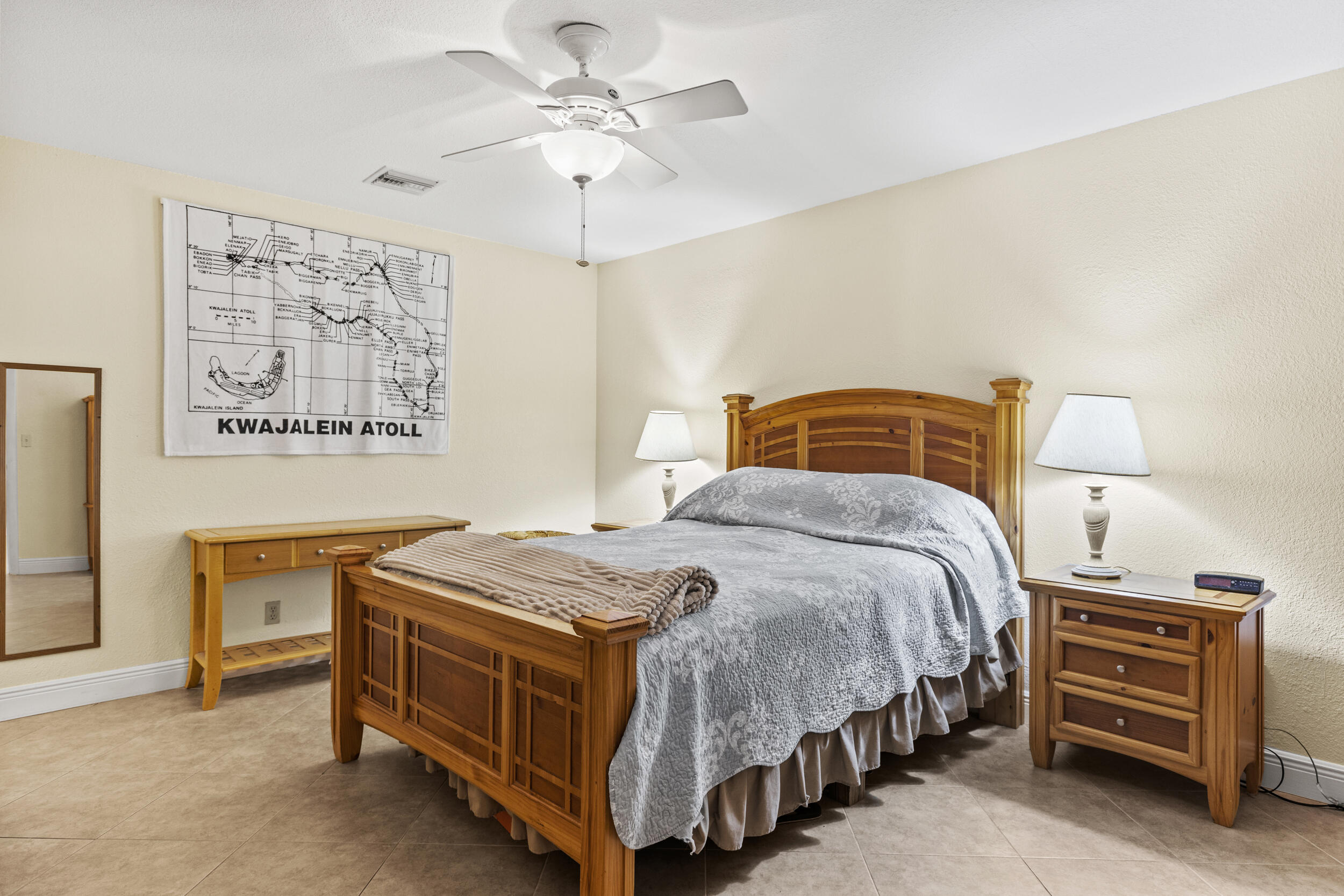 333 Masters Road Palm Springs, FL 33461 - Photo 10 of 15 a bedroom with a bed and a chandelier