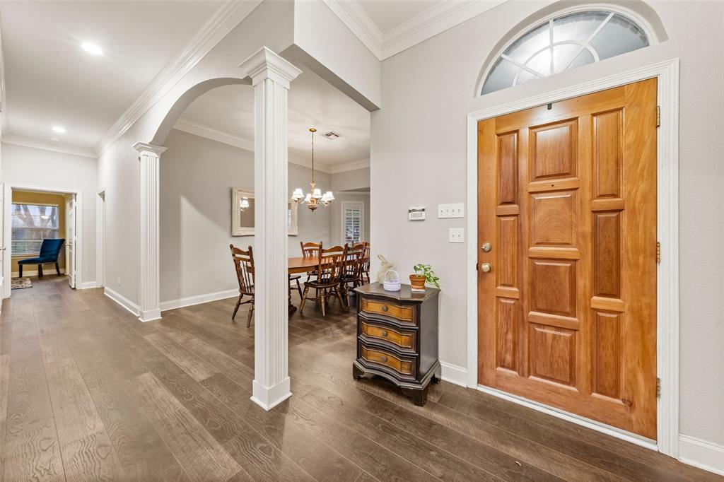 517 Chado Lane Robinson, TX 76706 - Photo 2 of 40 Entrance foyer featuring decorative columns, arched walkways, ornamental molding, and dark wood-style floors