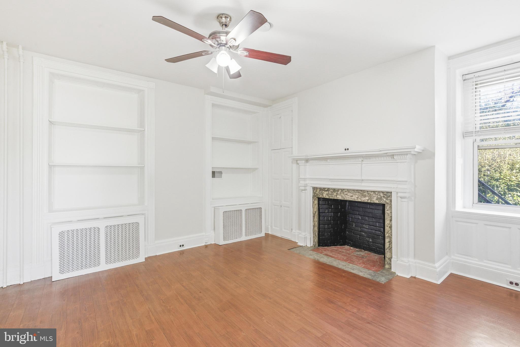 1834 Meetinghouse Road, Unit 1458 Upper Chichester, PA 19061 - Photo 14 of 42 a view of empty room with fireplace and wooden floor