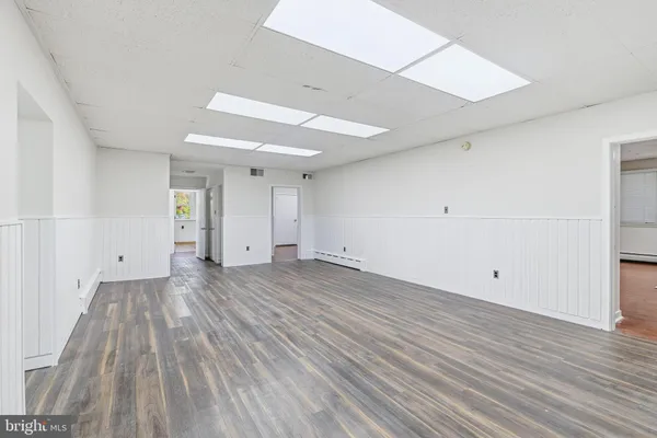 a view of a room with wooden floor