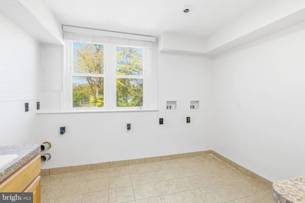 a view of a kitchen with wooden floor and a window