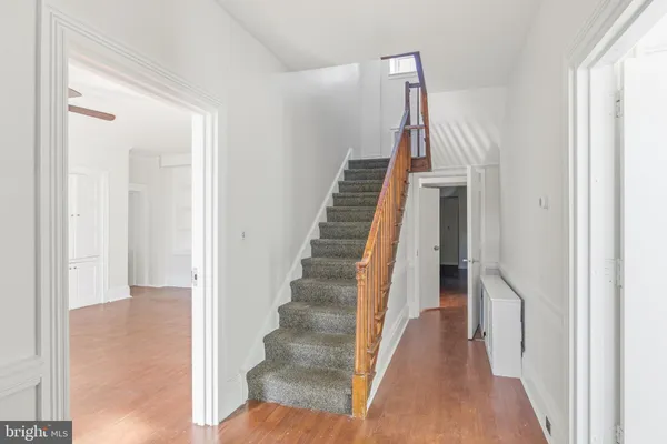 a view of a hallway with wooden floor and entryway